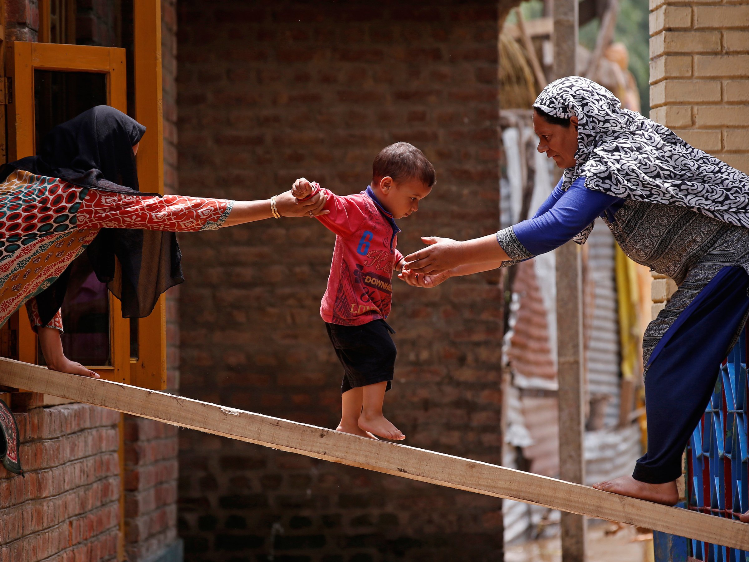 Child crosses plank