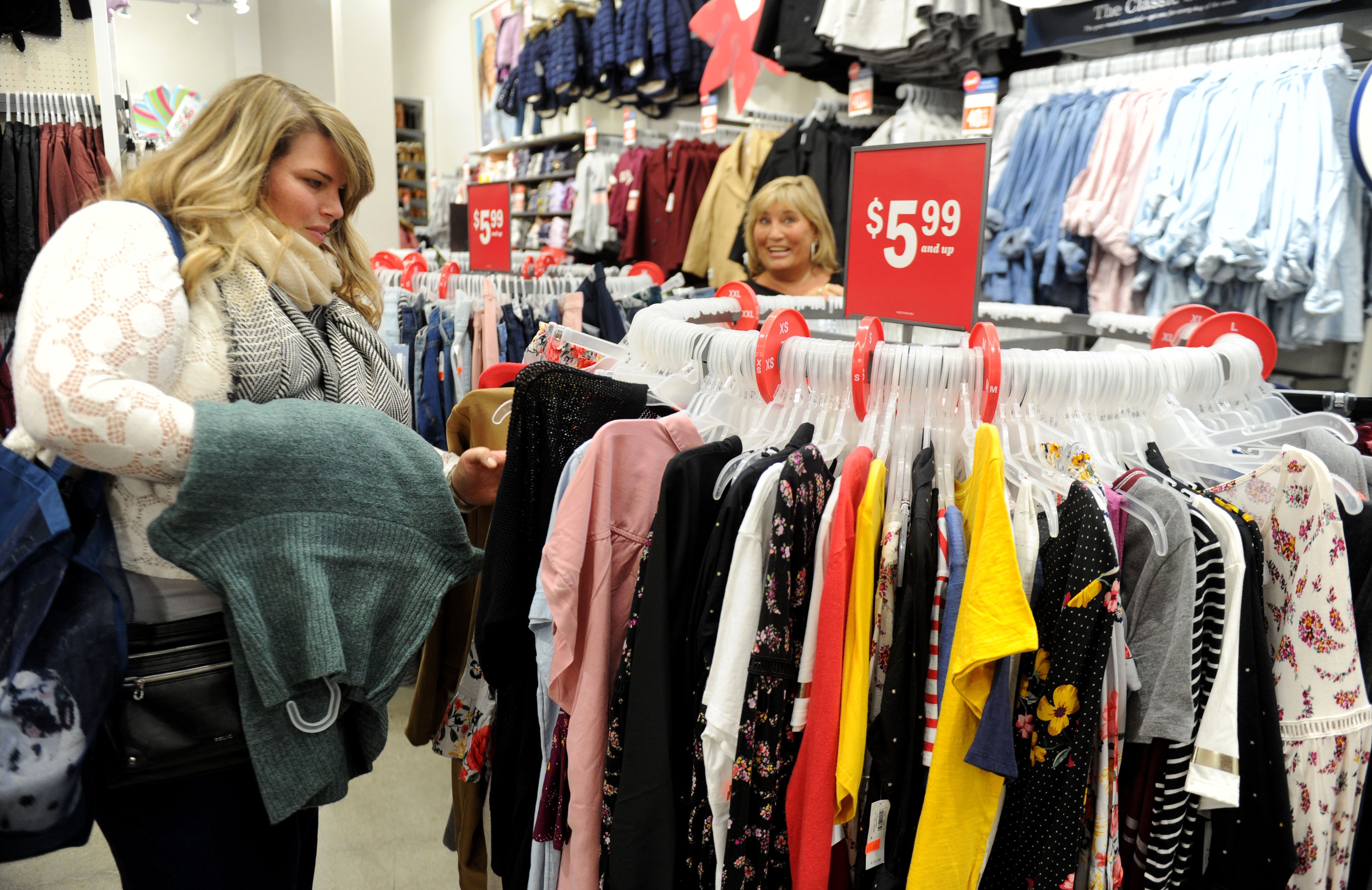 From left, Heather Roach, of Pasadena, looks at the Old Navy sale rack with her mom, Traci Schiller, of Ventura, at the Camarillo Premium Outlets.