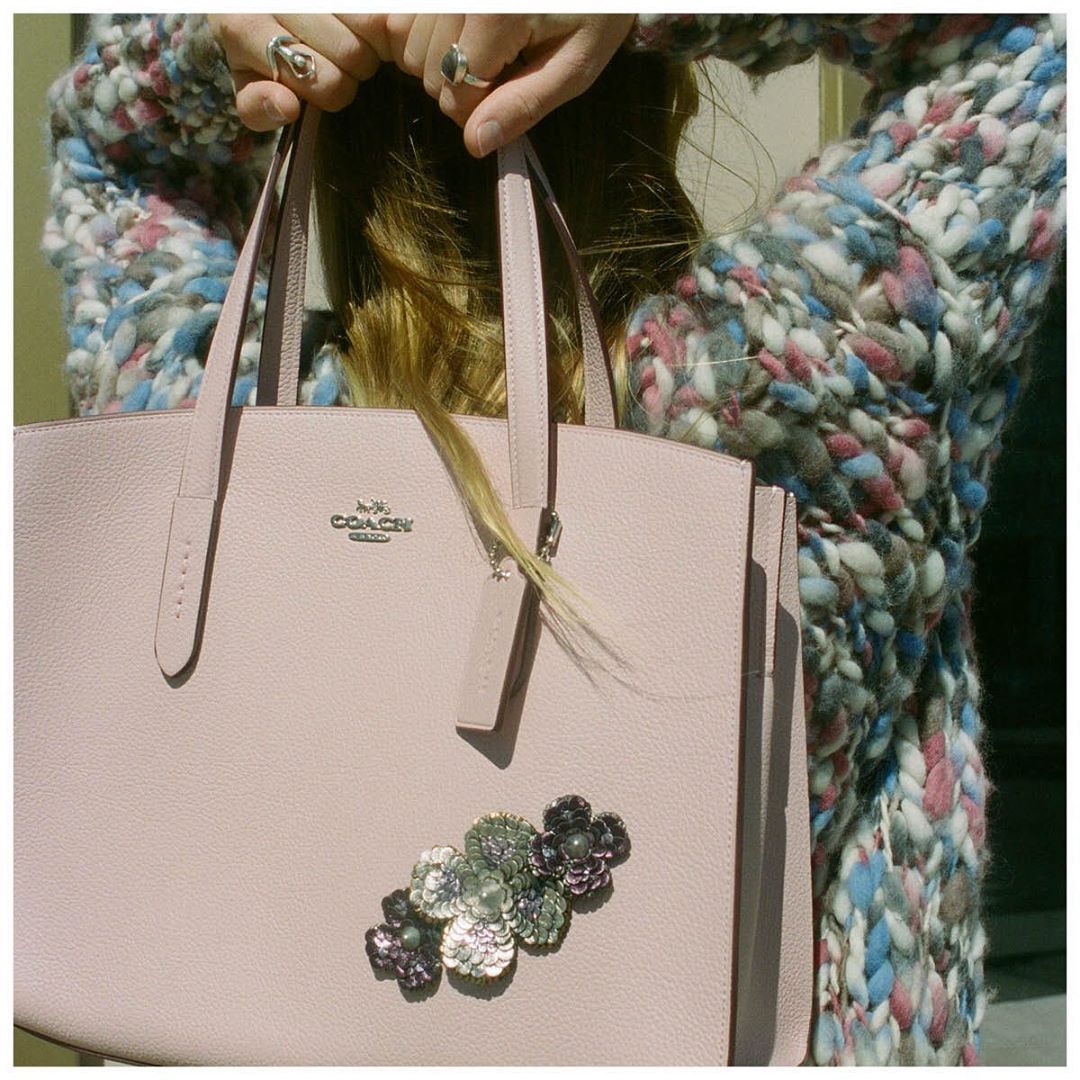 The Charlie Carryall was already pretty in pink. Blooms make it prettier. Share your #CoachCreate styles for a chance to be featuerd on our Instagram. #CoachNY