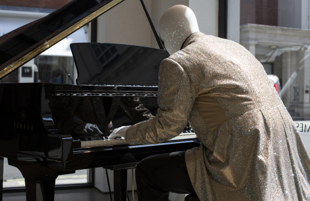 Savile Row Tailor Lights Up Window with Elton John Costumes
